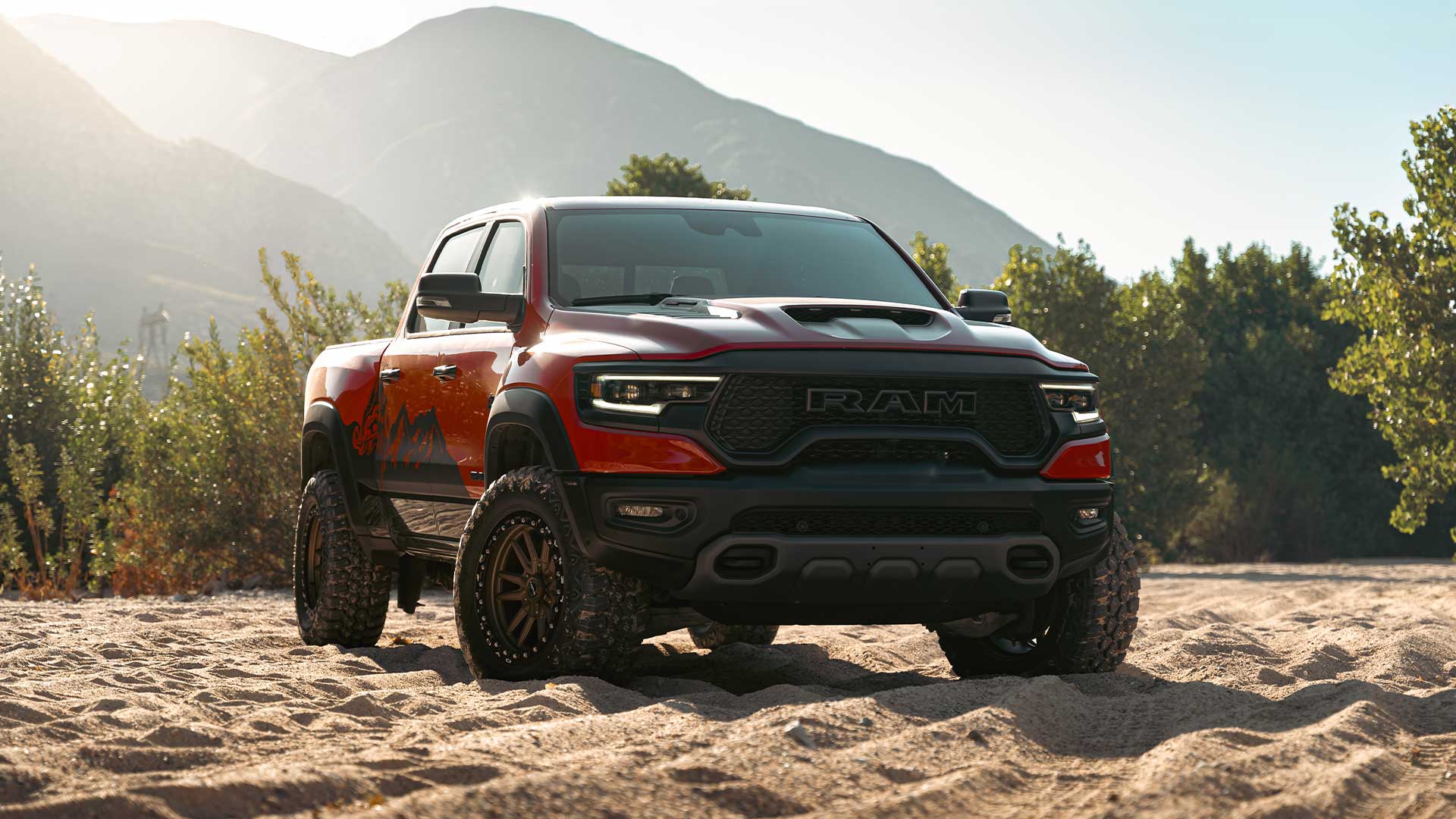 red dodge ram 1500 trx with rbp repulsor xt rx off road tires on sandy trail