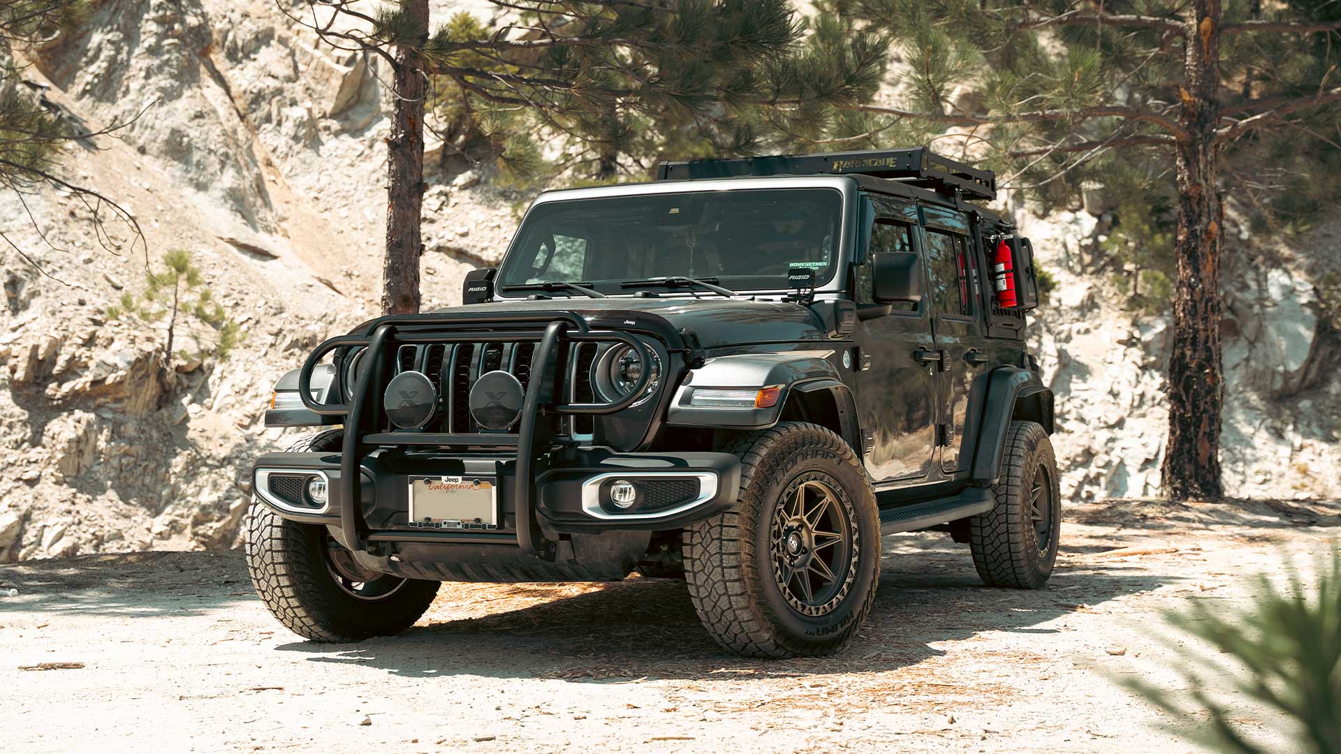 gray jeep wrangler 4xe with lionhart kilima all terrain tires on mountain road