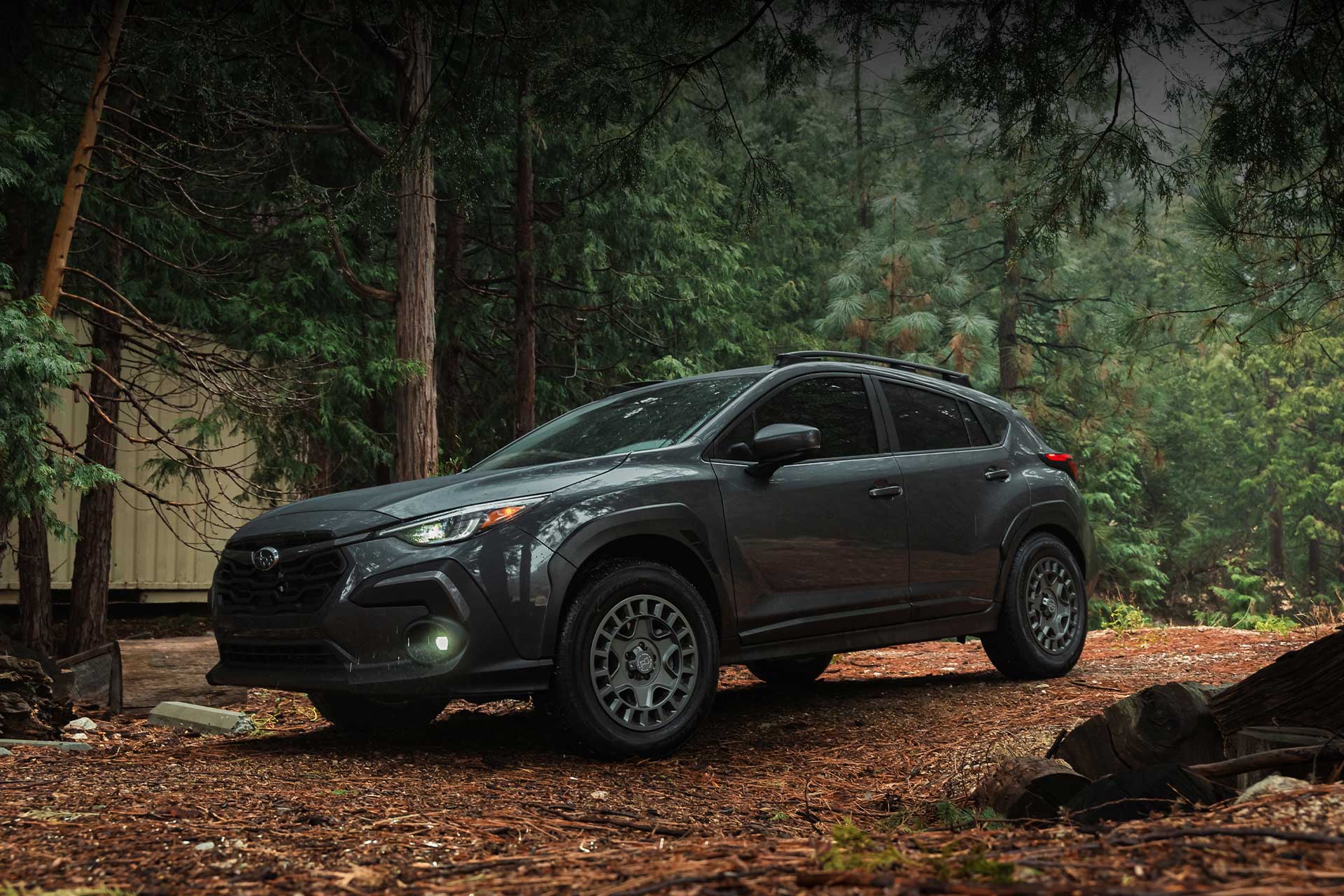 gray subaru crosstrek limited with lexani quattro tempo all weather tires in rainy forest